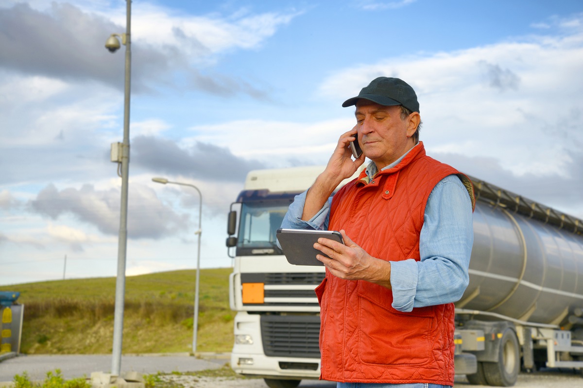 Truck driver in front of his truck