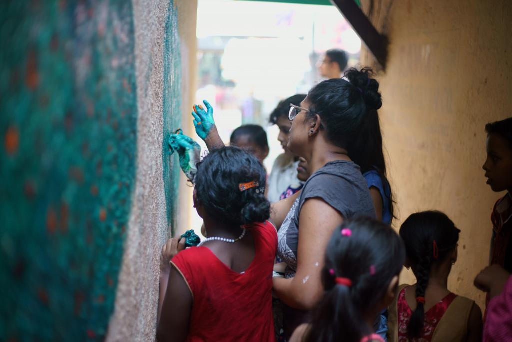 people painting a wall