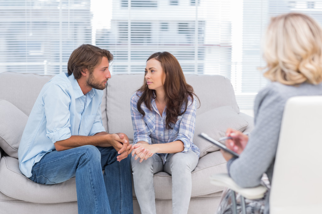 Couple resolving issue sitting in therapist office