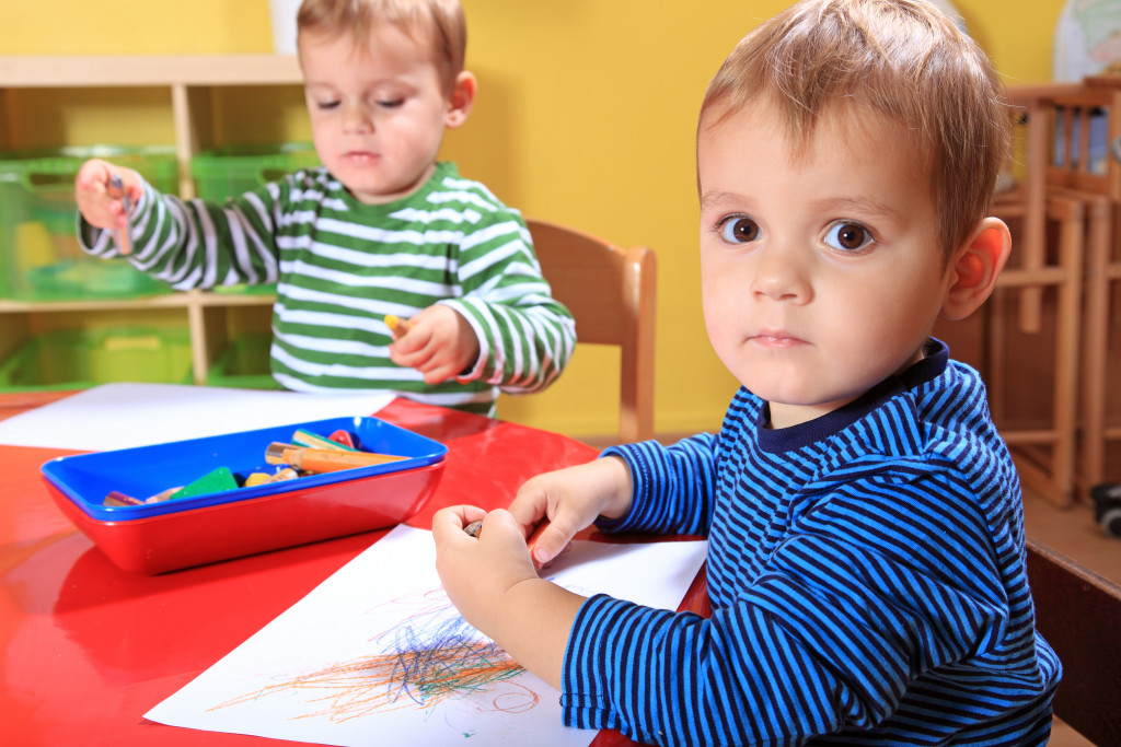 Children drawing on a sheet