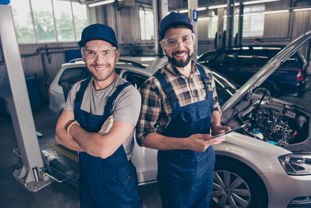 2 male mechanic in the auto workshop
