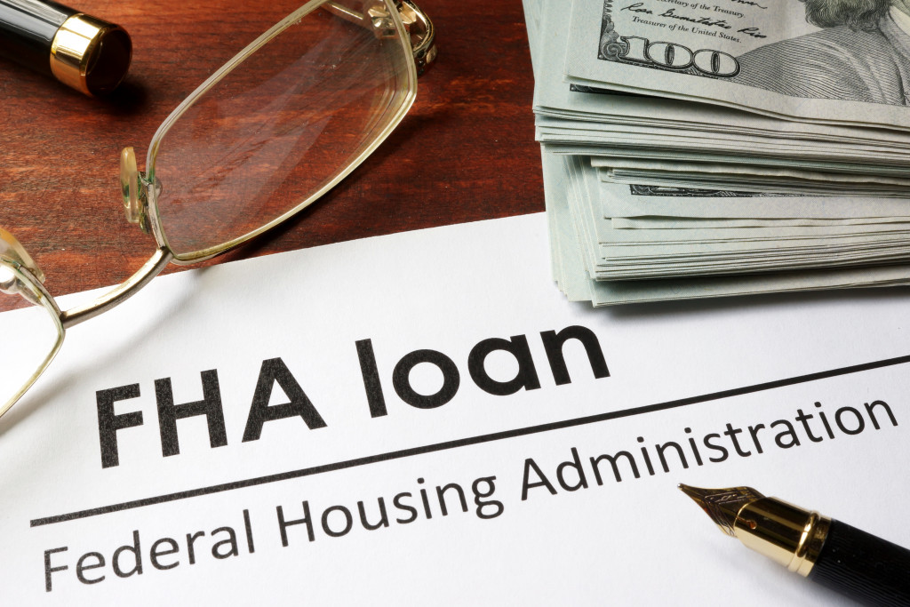 a FHA loan contract with glasses and money on the side