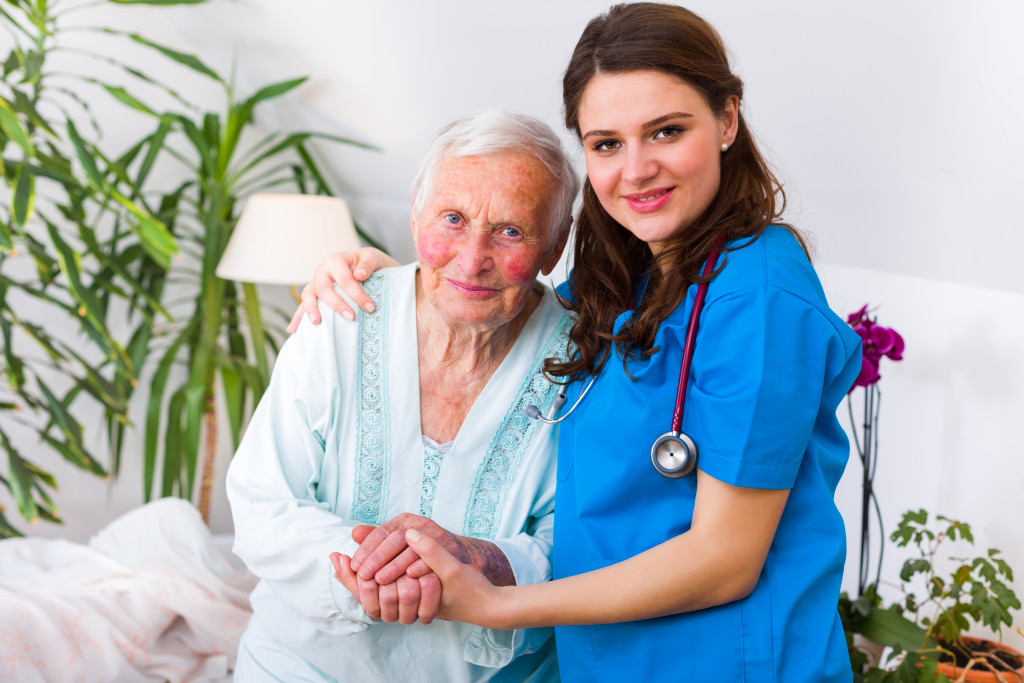 a female caregiver holding a senior patient