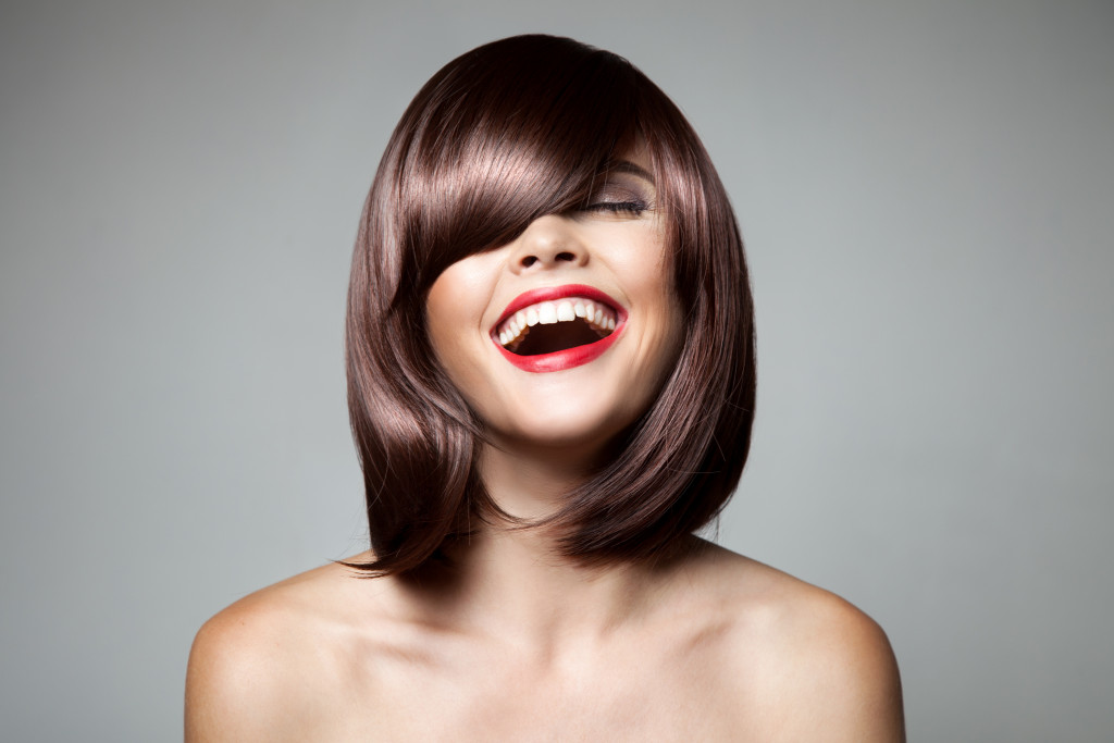 A smiling woman with short hair with bangs