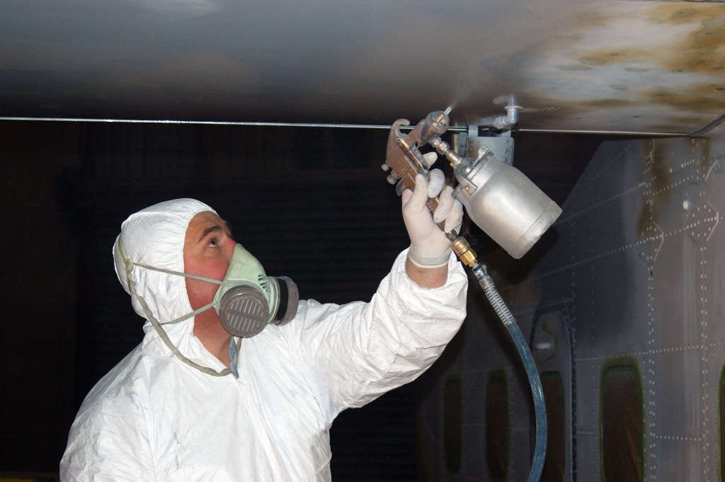 A worker painting an aircraft