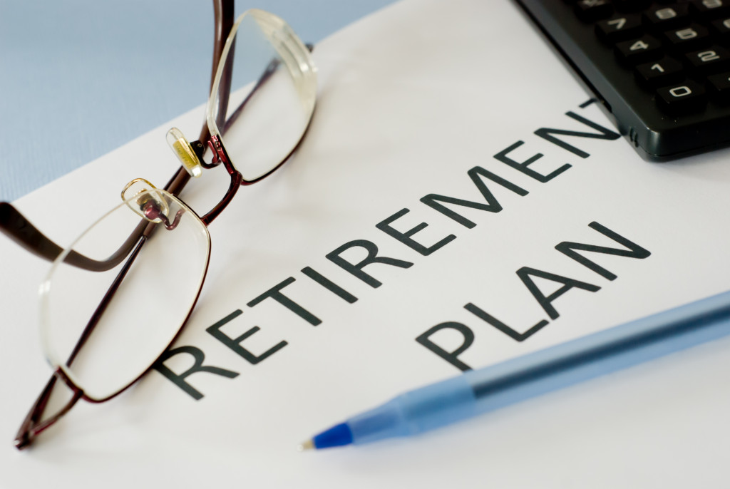 a document about retirement plan with pen and glasses on top