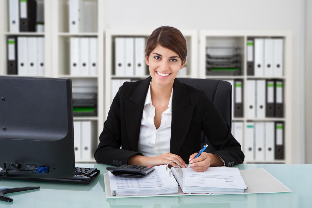 young accountant smiling in her office desk