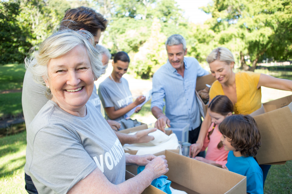 Volunteers sorting boxes outdoors on a sunny day