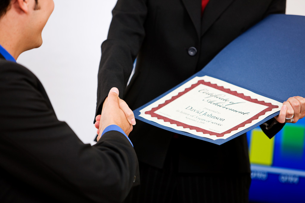 a business man getting a certificate