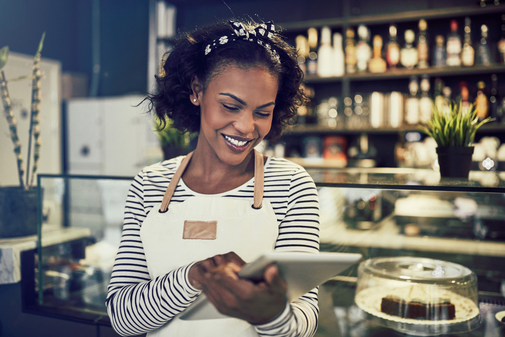 working with a digital tablet while standing in front of the counter