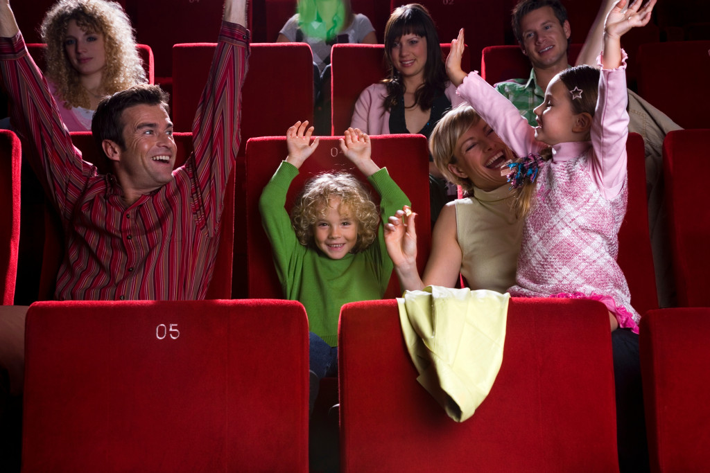 A family cheering inside a movie theater