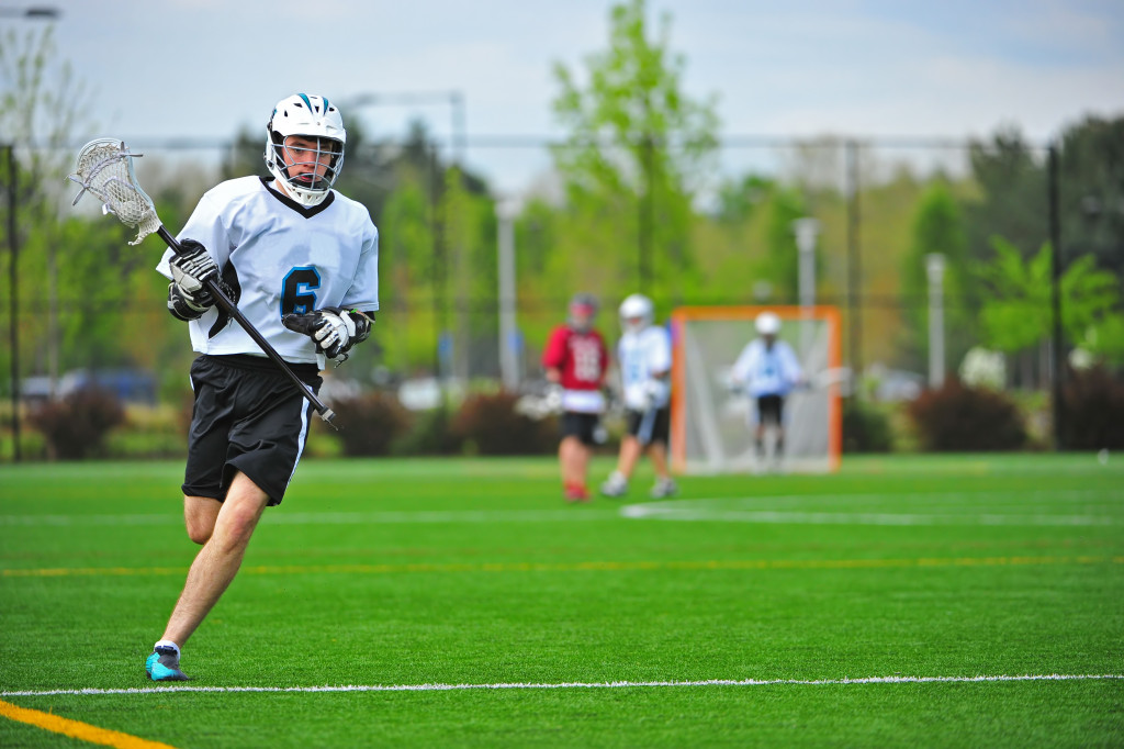 Young lacrosse player running on the field