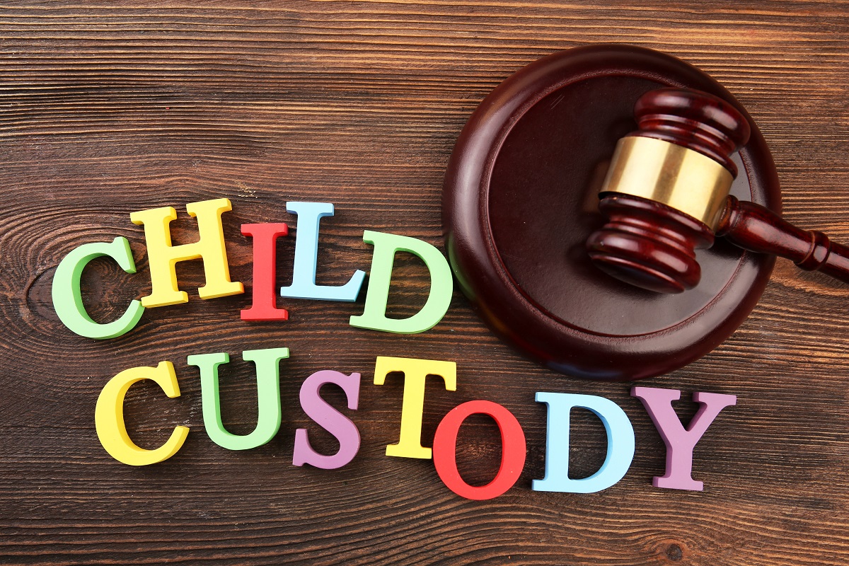 Colorful letters spelling child custody beside a gavel