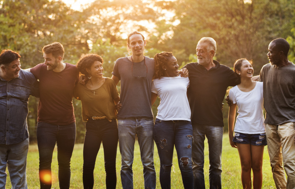 community members happily talking in the field