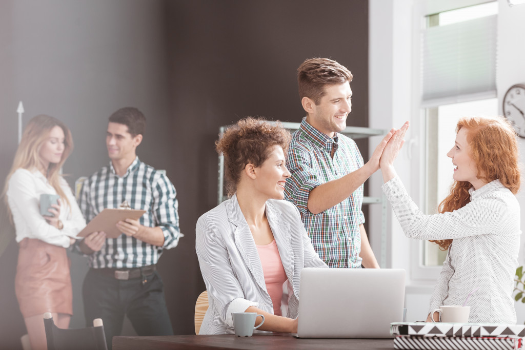 Employees collaborating while working on a project.