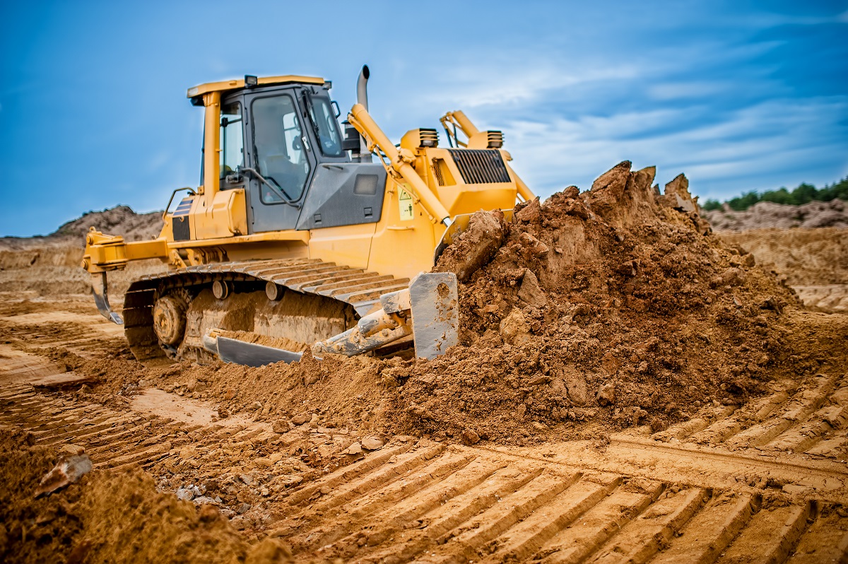 excavator working in highway construction site