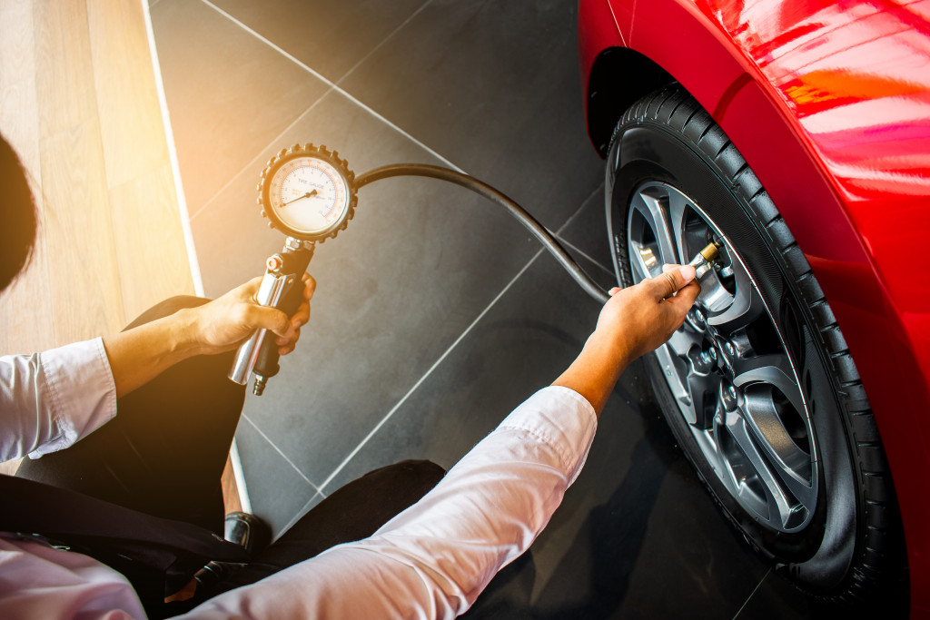 hand checking tire pressure