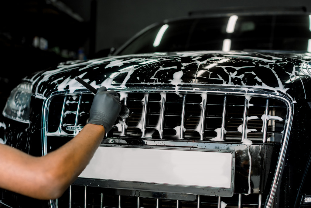 man cleaning a car in the garage