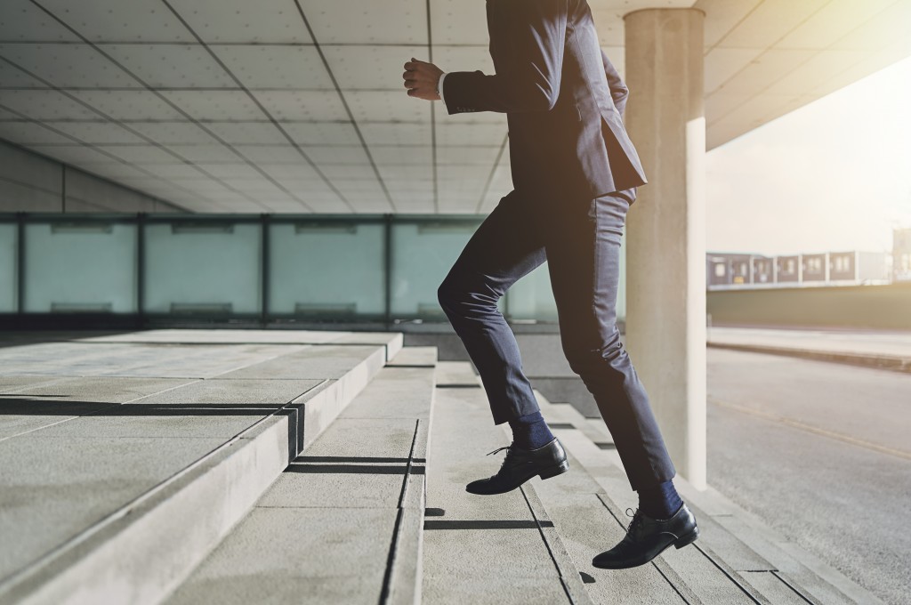 businessman running up the stairs