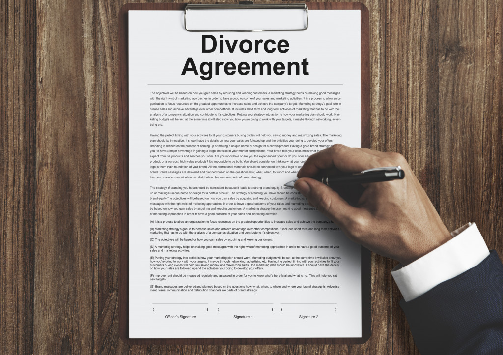 person signing divorce paper