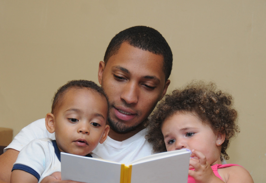 father reading something for his children