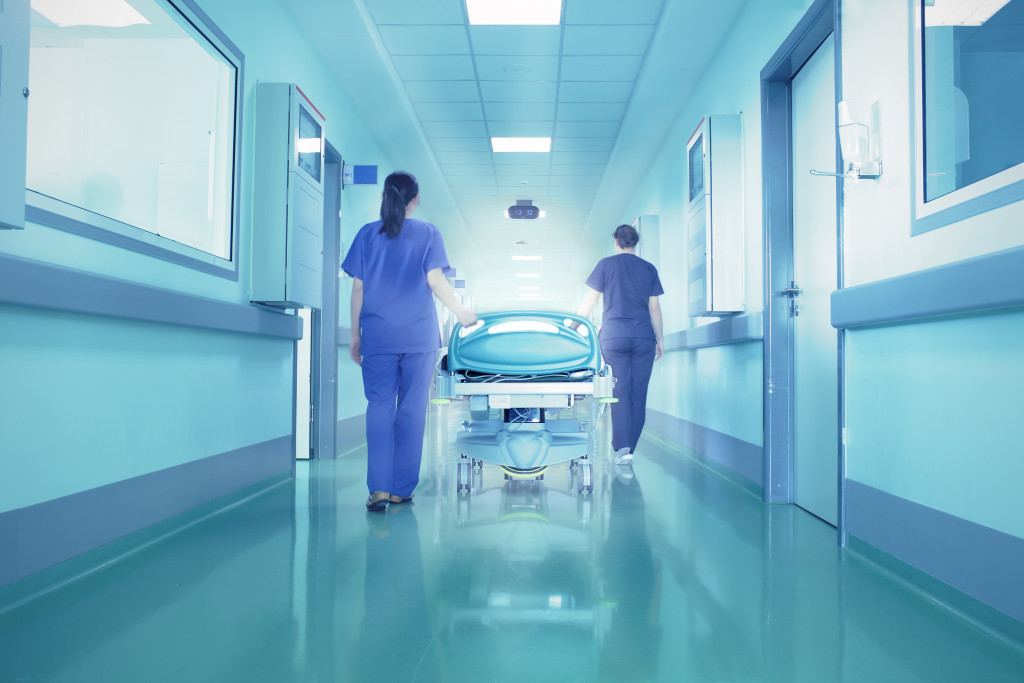nurses pushing a hospital bed