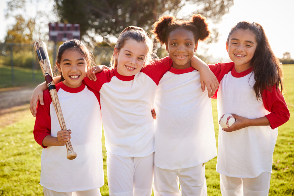 little girls playing baseball