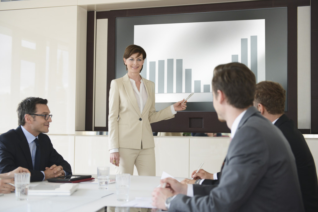 a professional woman in a meeting showing a presentation