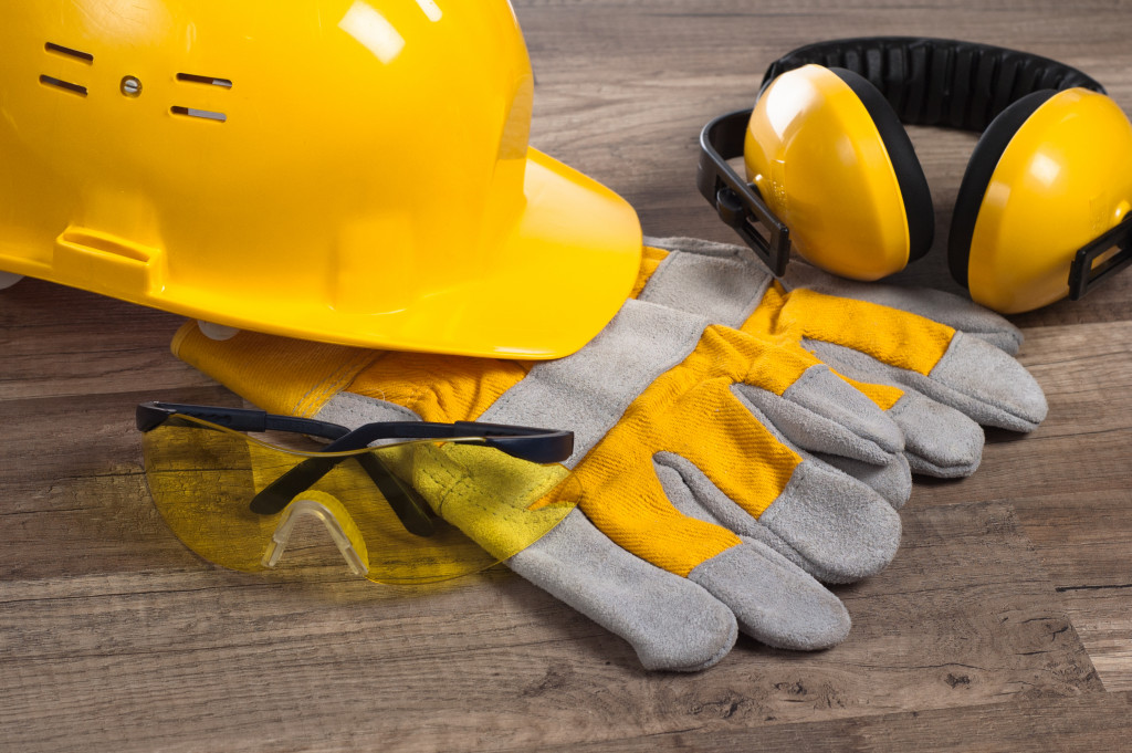 Hard hat, construction gloves, earmuffs, and eye protection glasses