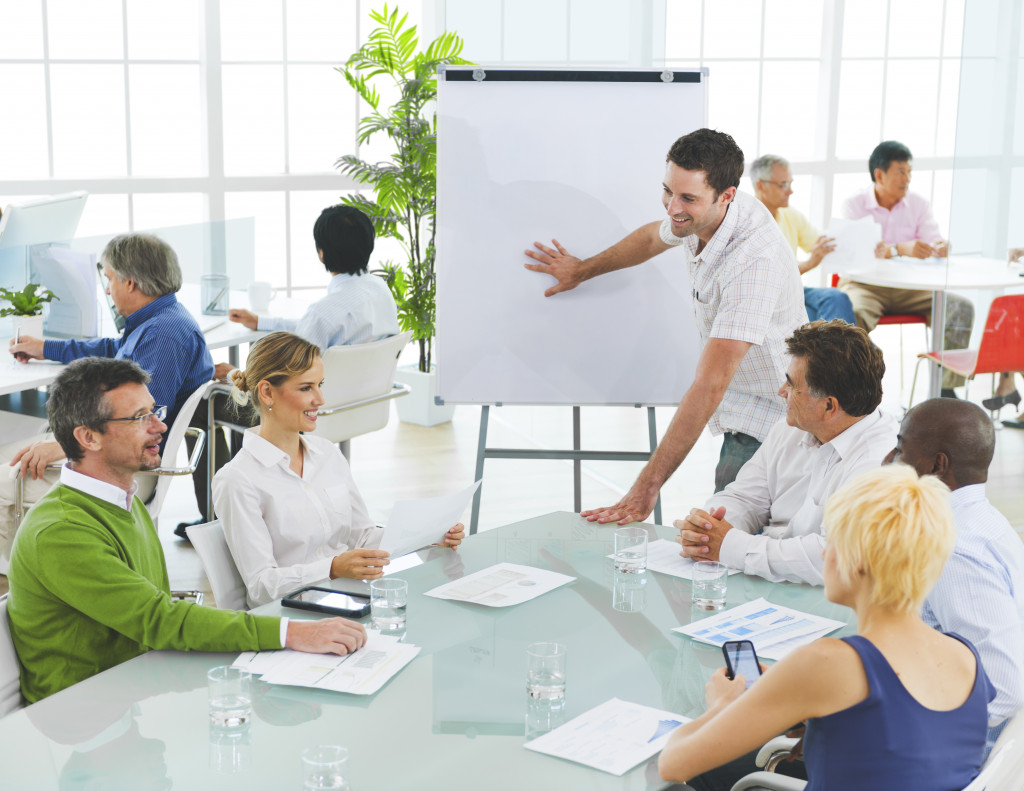 Employees discussing innovative ideas inside an office with an open layout.