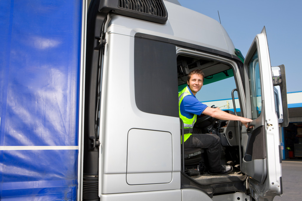 A truck driver at the driver's seat of his truck