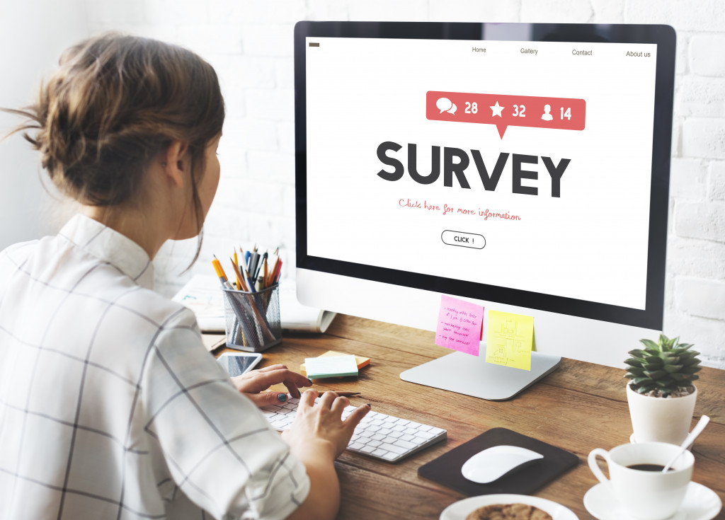 Young woman checking a customer survey on a computer.