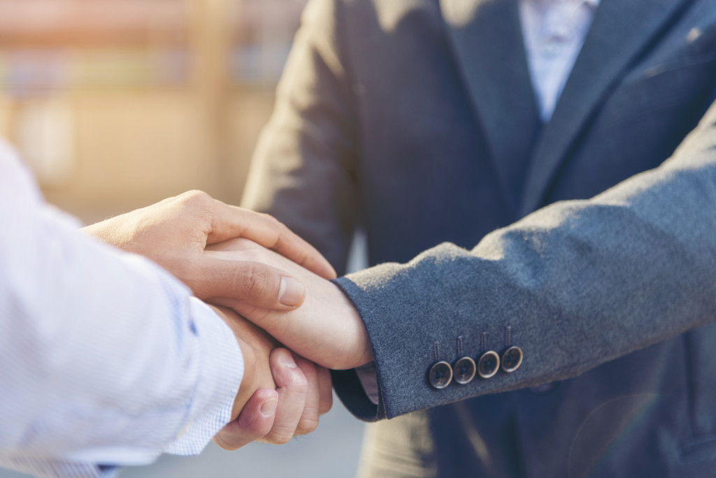 two men shaking hands in assurance representing lawyer