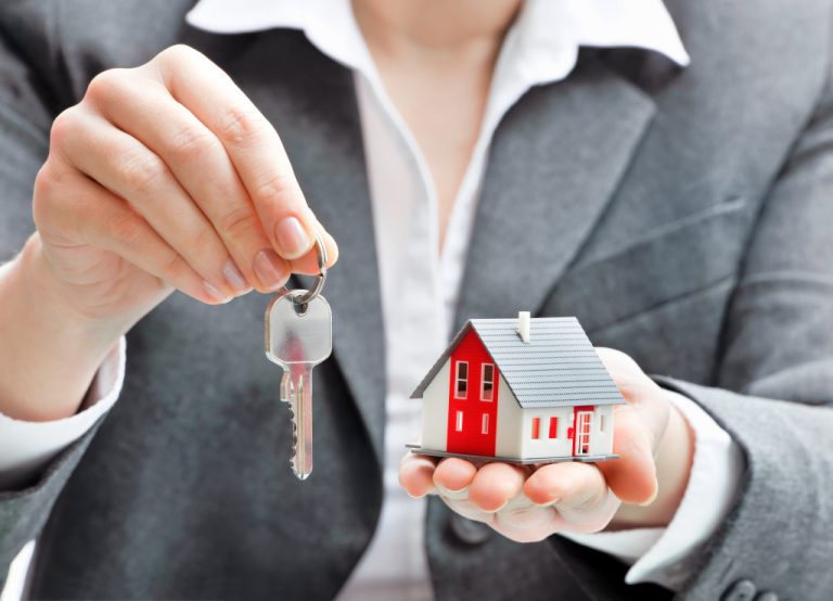 Real estate agent handing house key