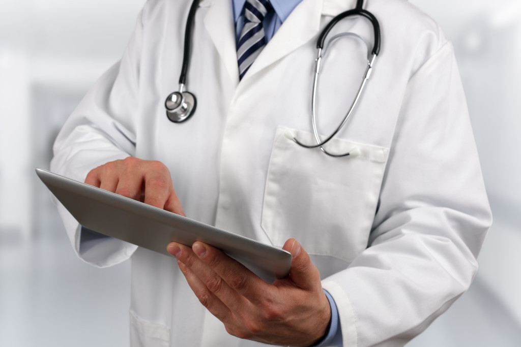 doctor holding tablet