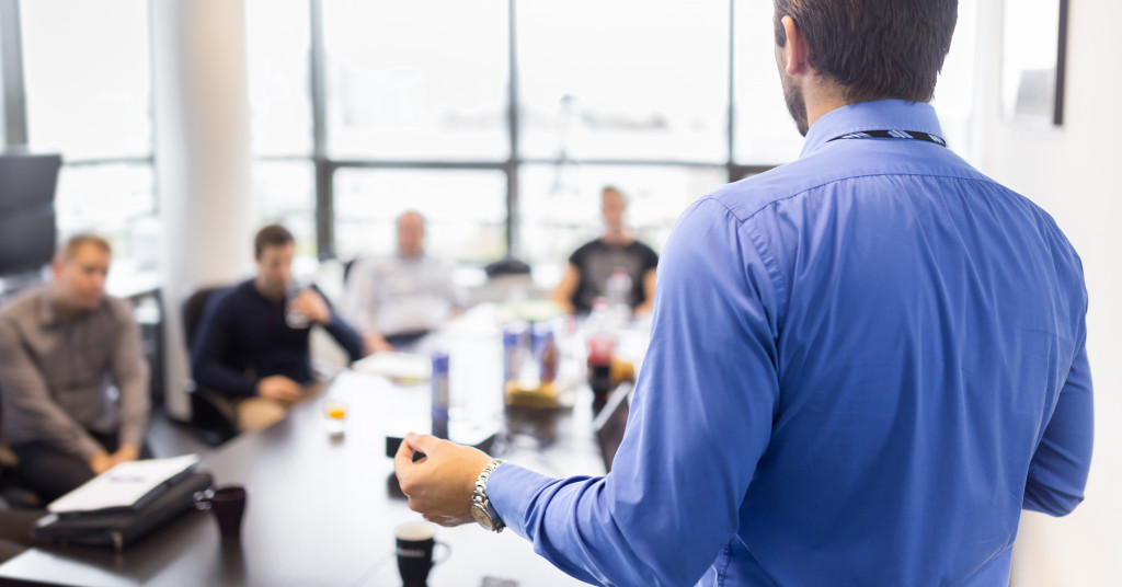 Business executive delivering a presentation to his colleagues