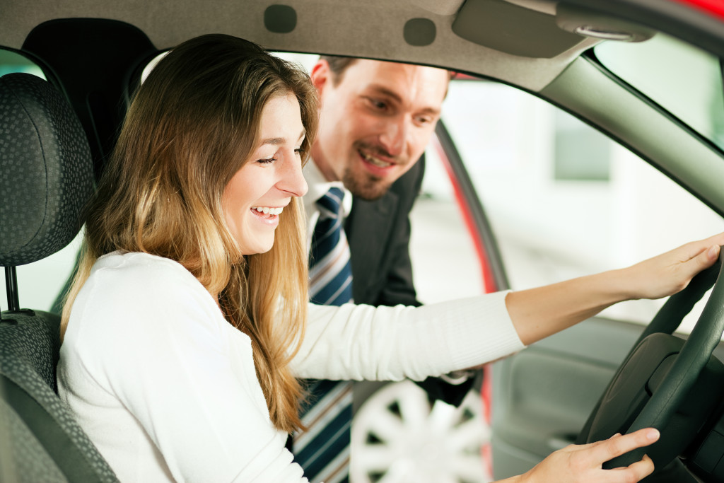 woman in her brand new car