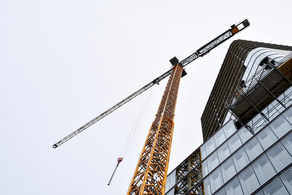 construction crane next to a partially built building
